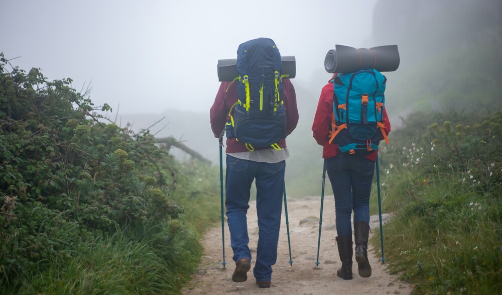 hikers walking with backpack and poles